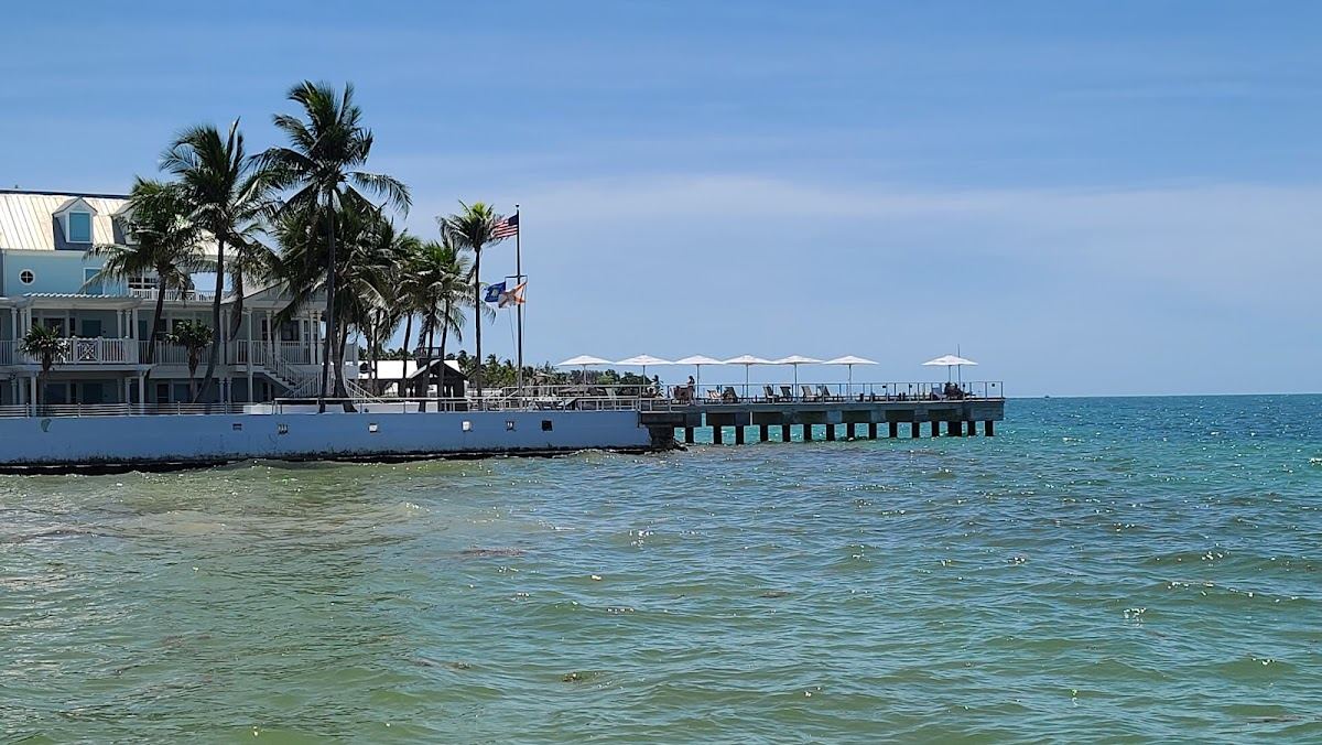 The calm water and pier beside the small sand of South Beach in Key West