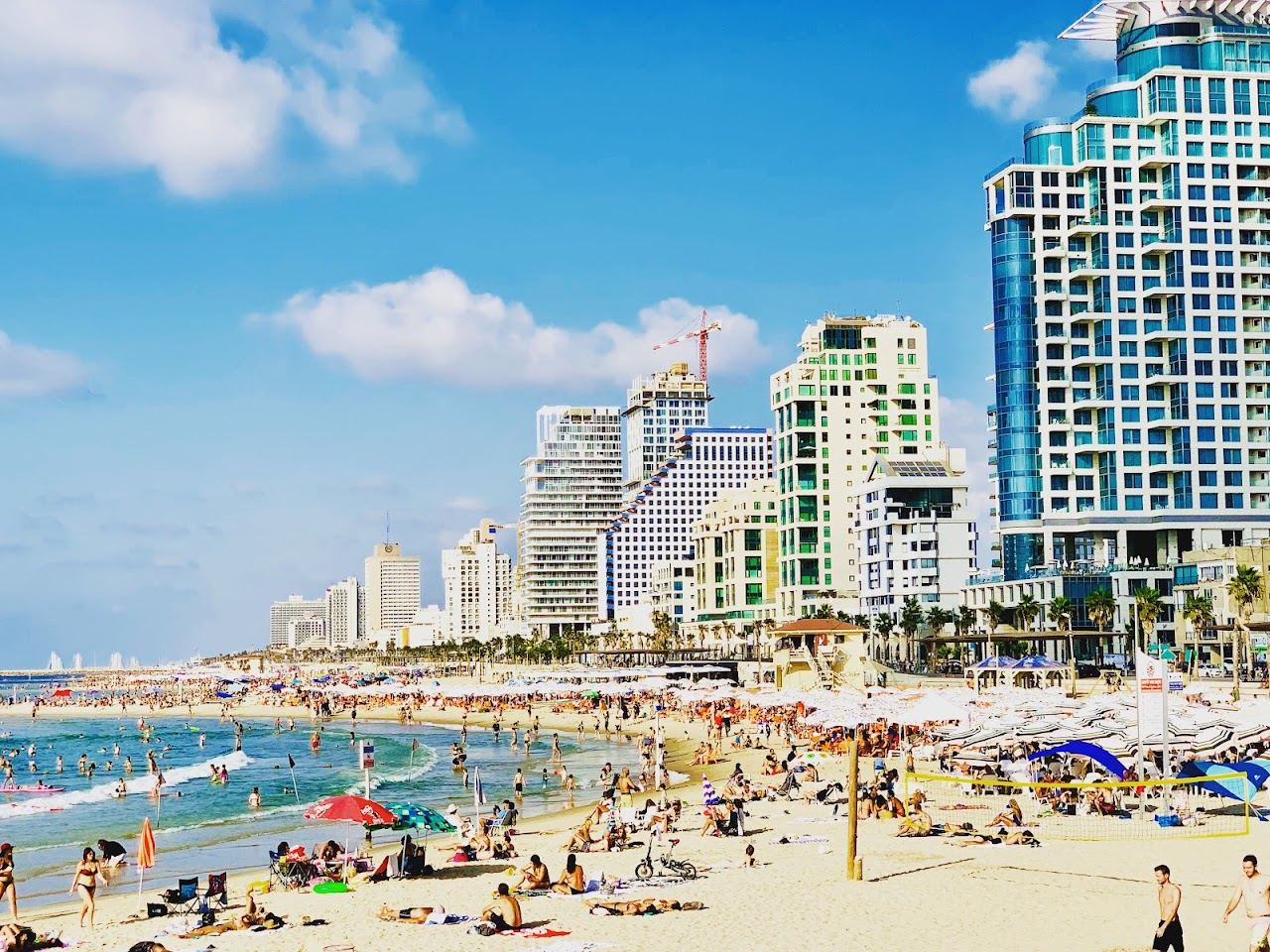 The soft golden sand and busy promenade of Frishman beach in central Tel Aviv