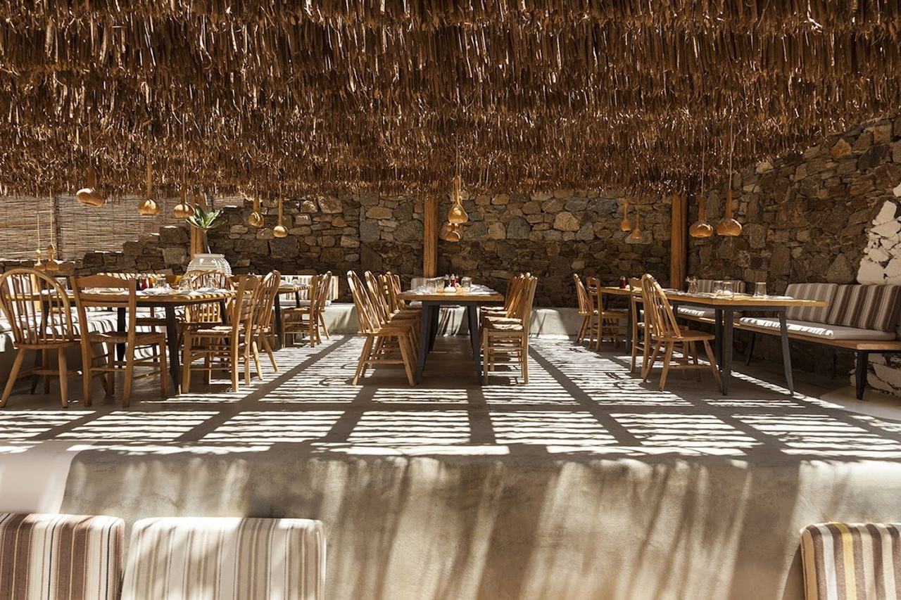 Rustic Cycladic beach lounge and sunset terrace on the sand at Ftelia on Mykonos