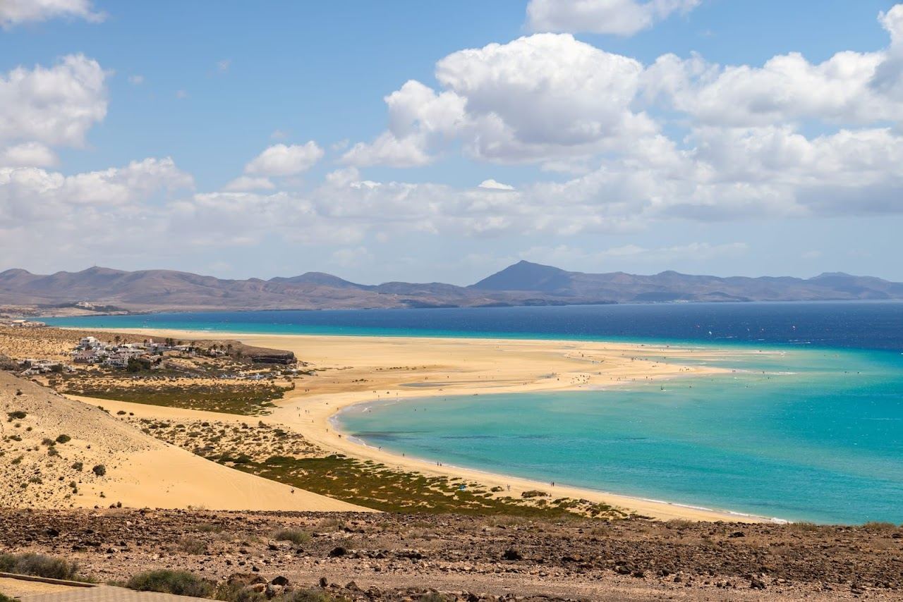 Still turquoise lagoon and pale sand on a sheltered calm water beach in Fuerteventura