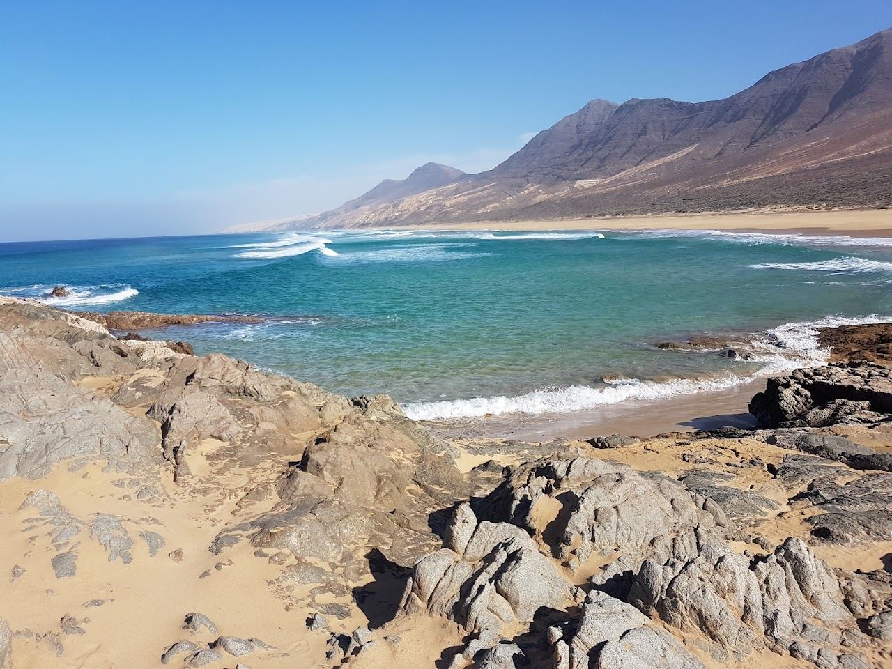 Wild empty golden sand stretching under the Jandia mountains at Cofete in Fuerteventura