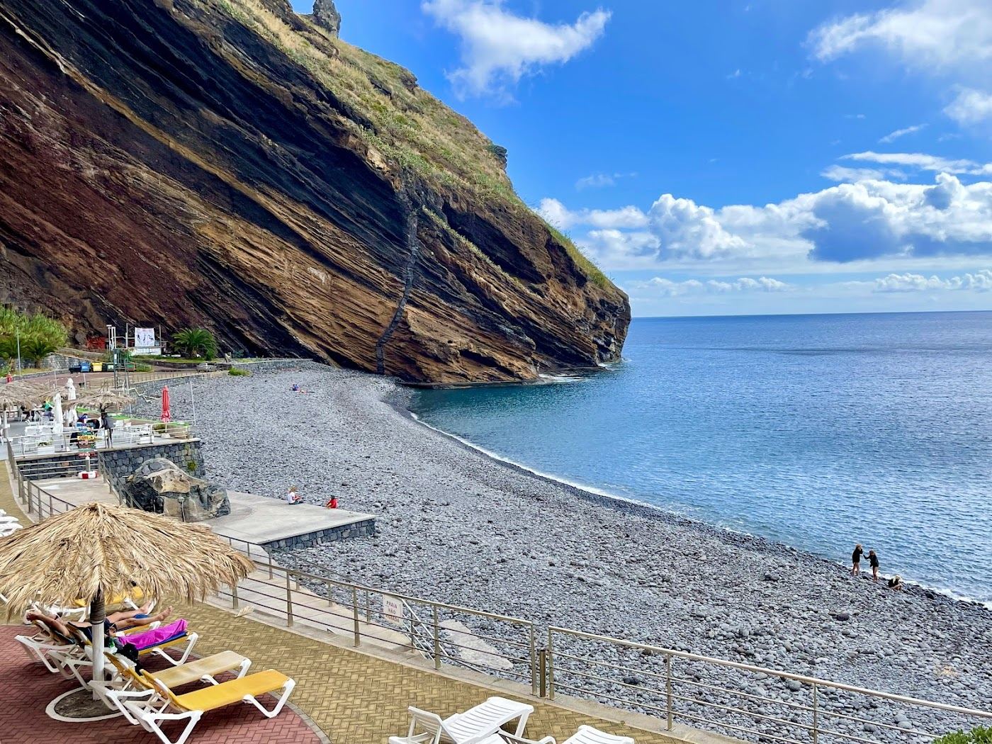 Pebble beach below high cliffs reached by cable car at Ponta do Garajau on the east coast of Madeira