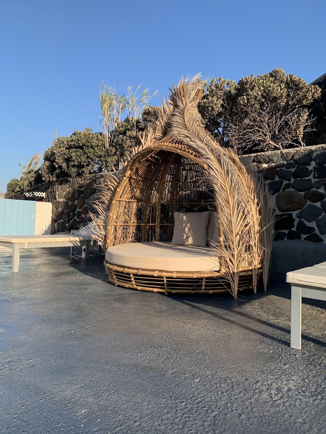 Sunbeds and a small dock at the quiet Gialos cove near Akrotiri on the southwest coast of Santorini