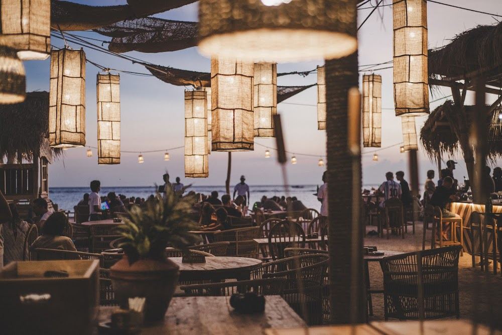 Sunbeds and bohemian beach setup at La Cala beach club on Gili Trawangan