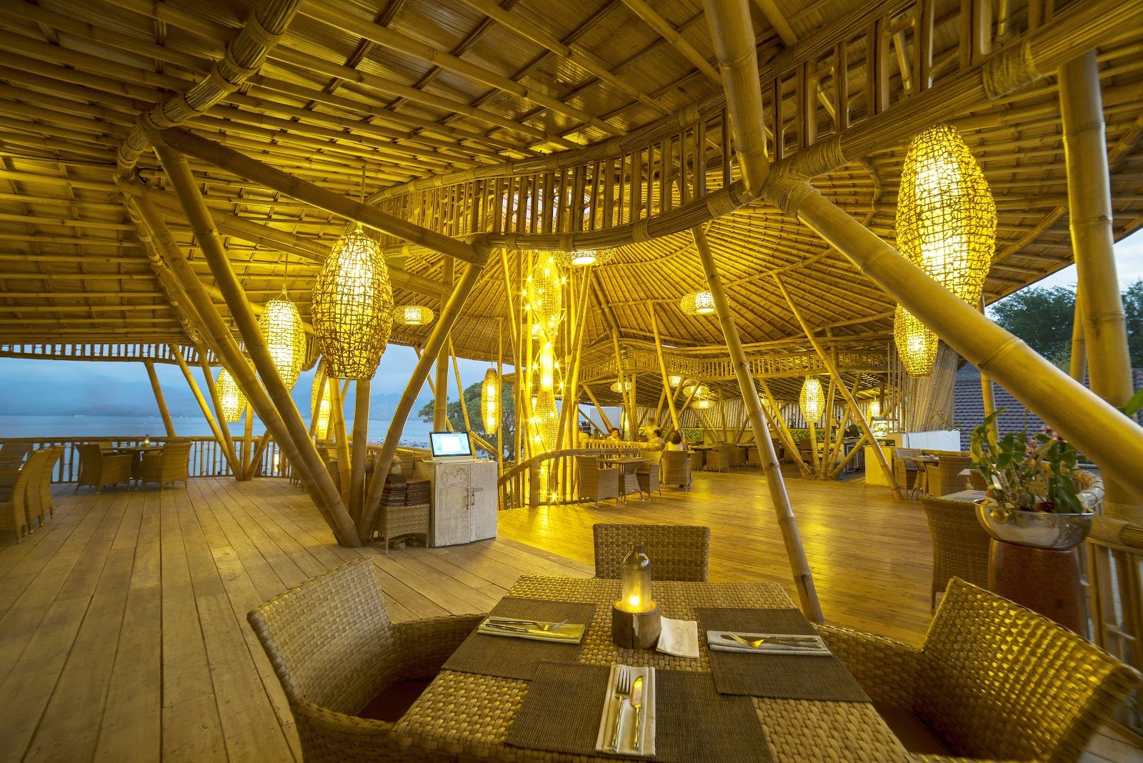 Beach loungers and palms facing the sea at a sunset beach club on Gili Trawangan