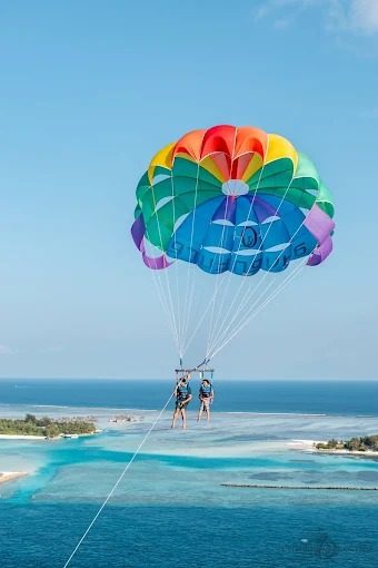 Parasail and jet ski activity off the busy sand at Baga Beach in North Goa