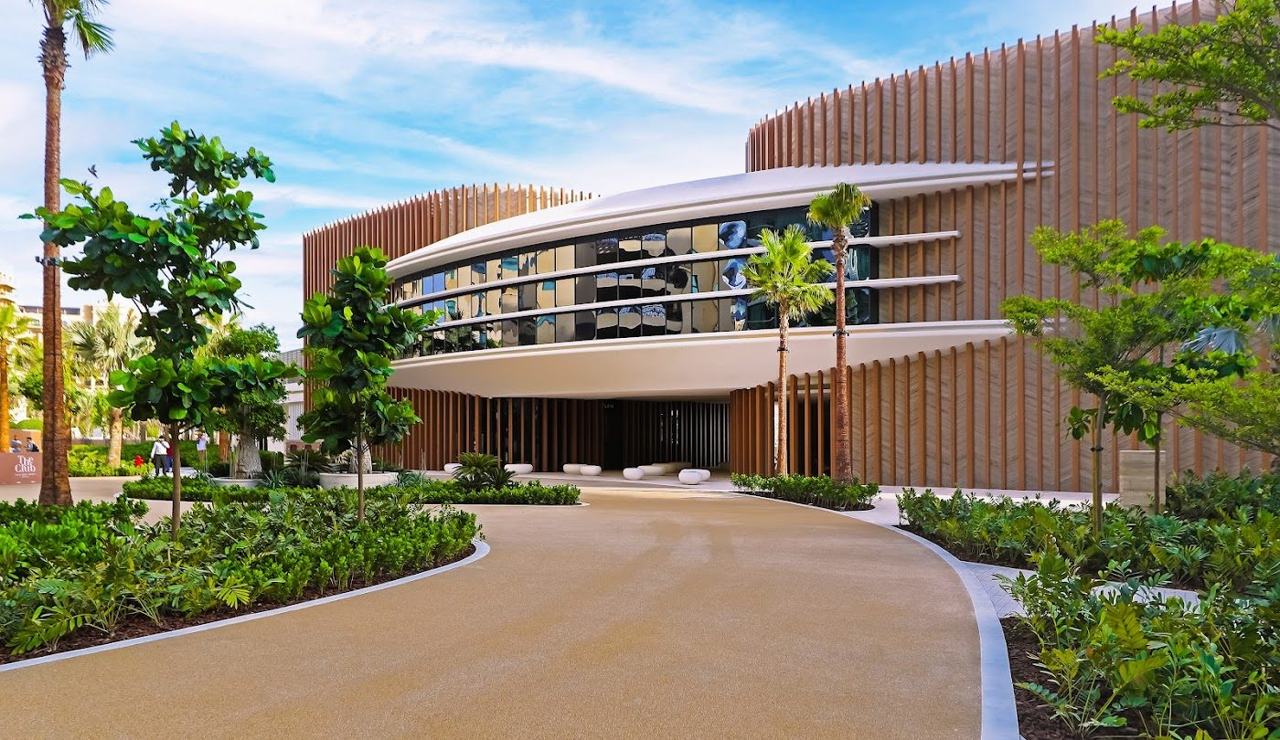 A polished beach club with daybeds beside the warm gulf where groups gather in Dubai