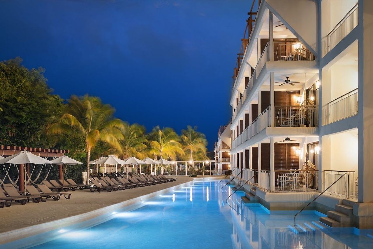 A long warm beach below a large resort on the Riviera Maya in Mexico
