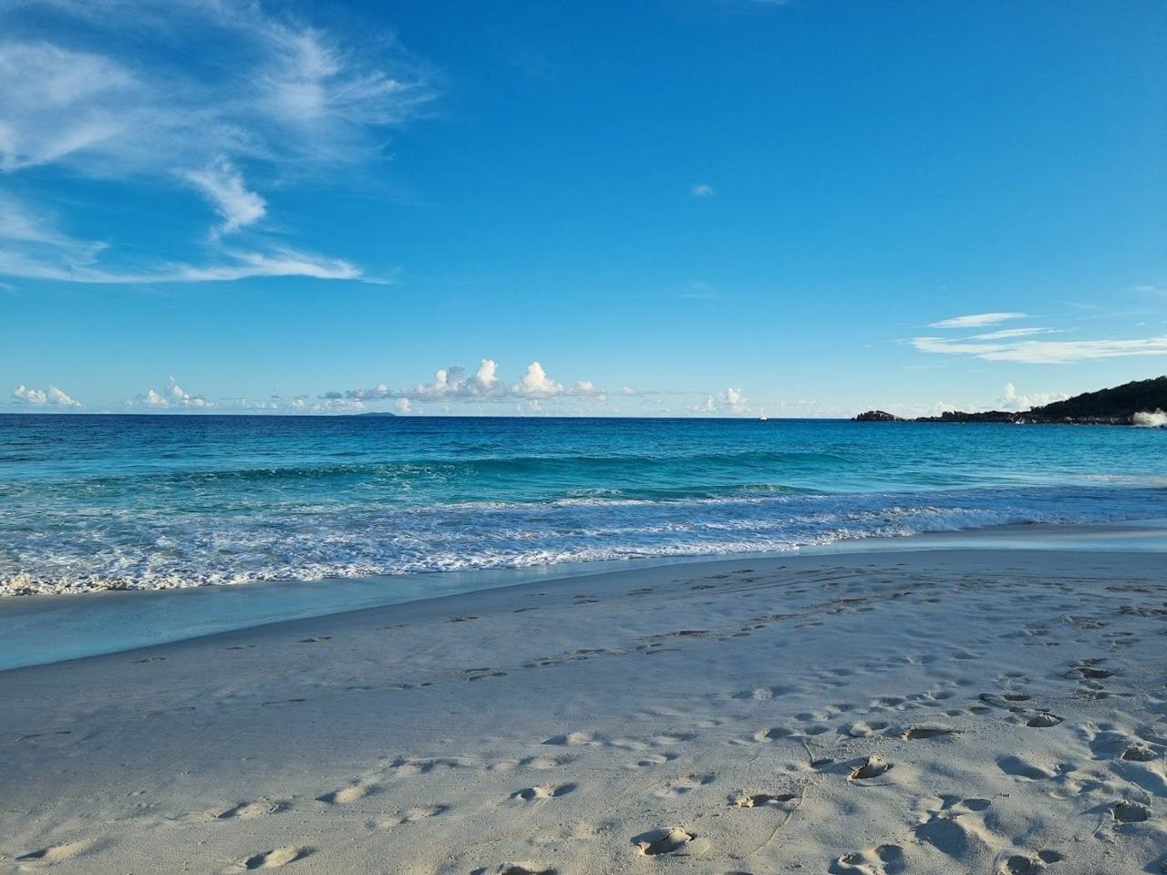 Breaking waves and open sand at Grand Anse on the south east coast of La Digue