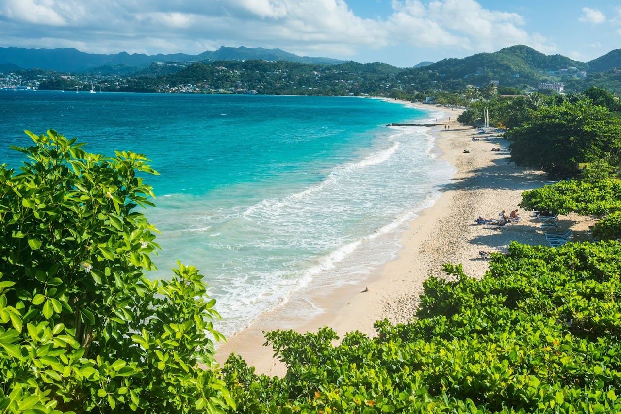 Calm turquoise water and pale sand at Grand Anse Beach in Grenada in the Caribbean