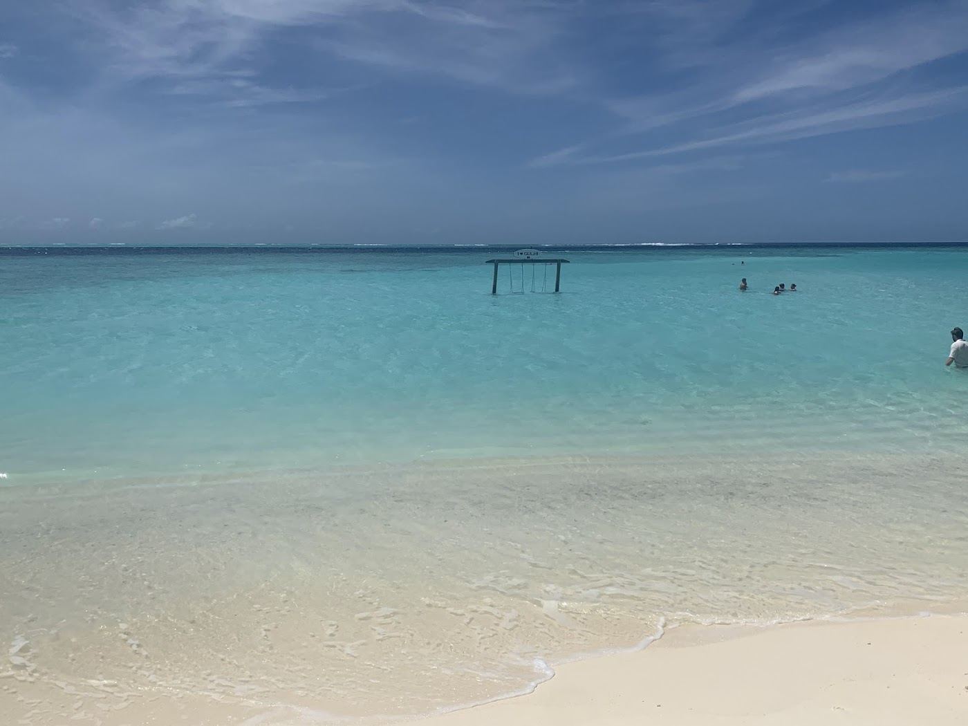 Calm shallow turquoise lagoon at the bikini beach on Gulhi in the Maldives
