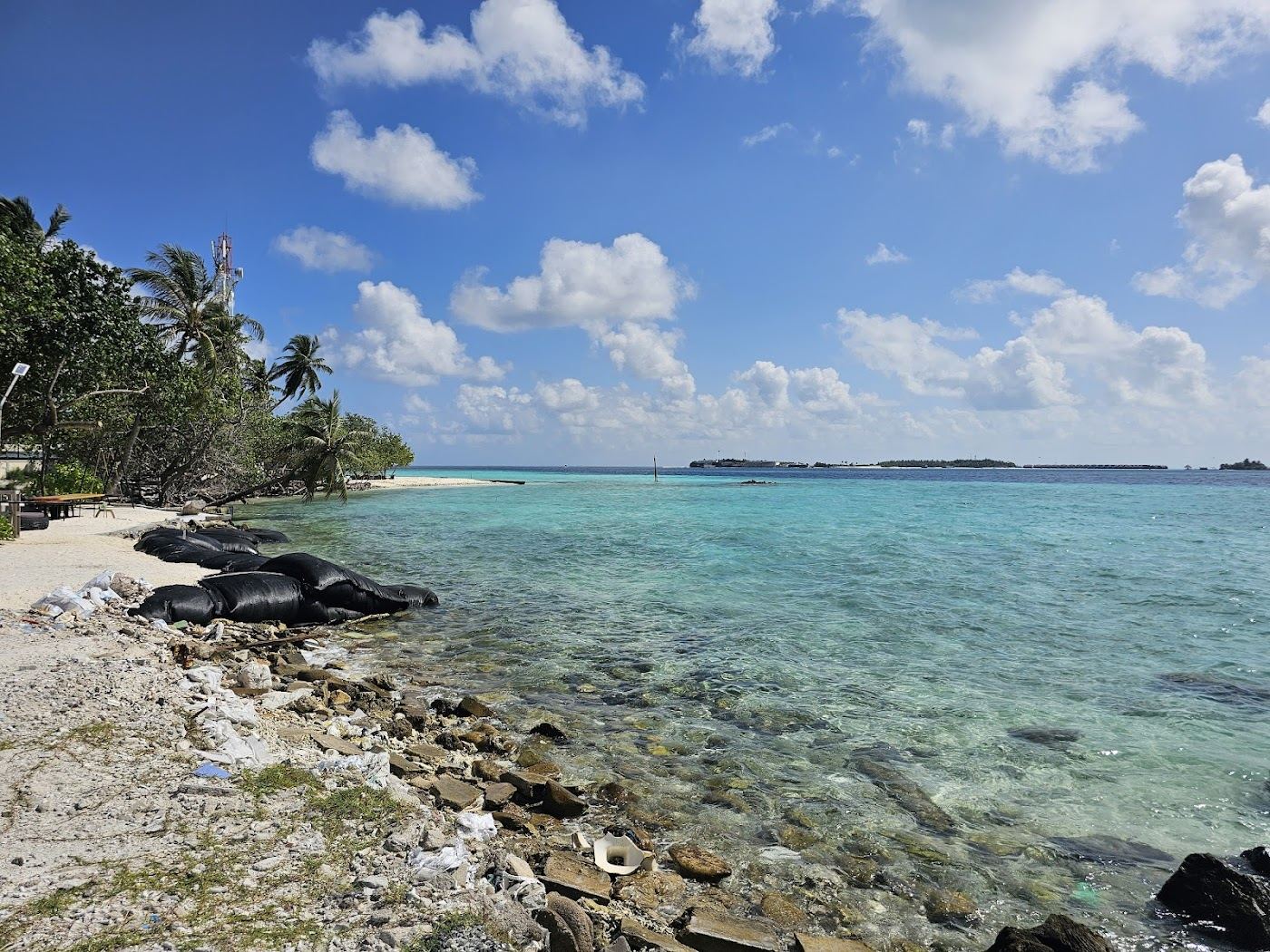 Soft white sand and clear shallow water at the bikini beach on Gulhi in the Maldives