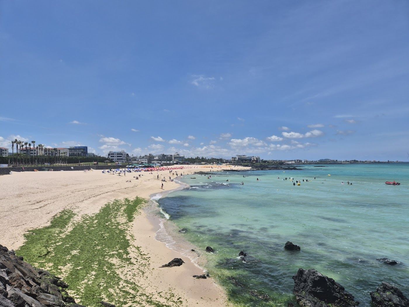 Golden sand and calm water at Gwakji Beach in Aewol on the west coast of Jeju Island