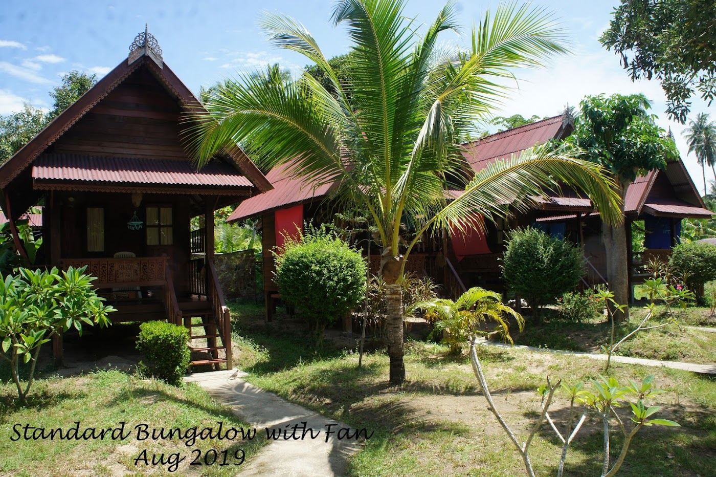 A beachfront resort restaurant and loungers on the calm cove at Haad Salad in Koh Phangan