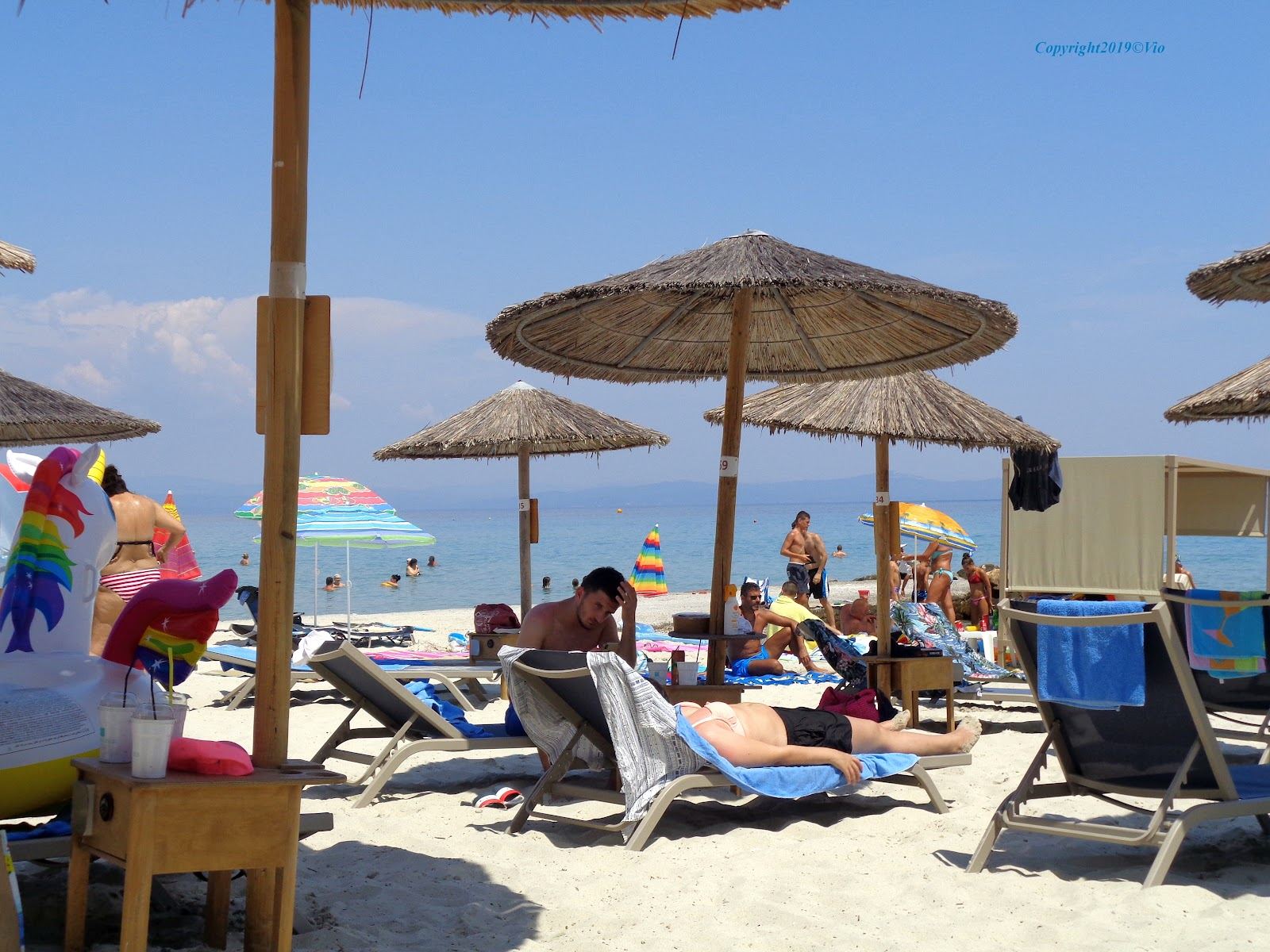 Clear water and a busy beach bar stretch on the Kassandra peninsula at Kallithea in Halkidiki
