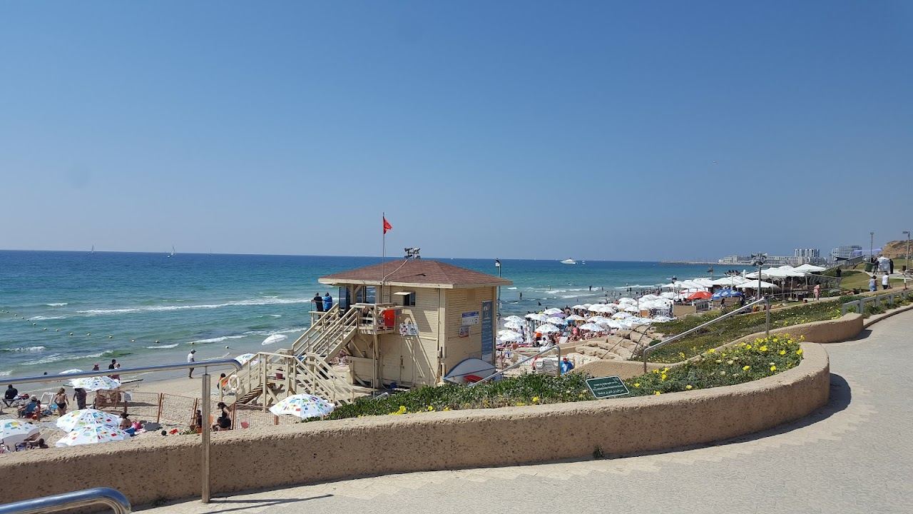 The quiet soft sand and open sea of Hatzuk beach below the cliff in northern Tel Aviv