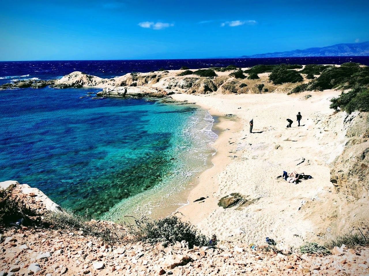 The vivid turquoise water of the small Hawaii cove beside the Alyko headland on the southwest coast of Naxos