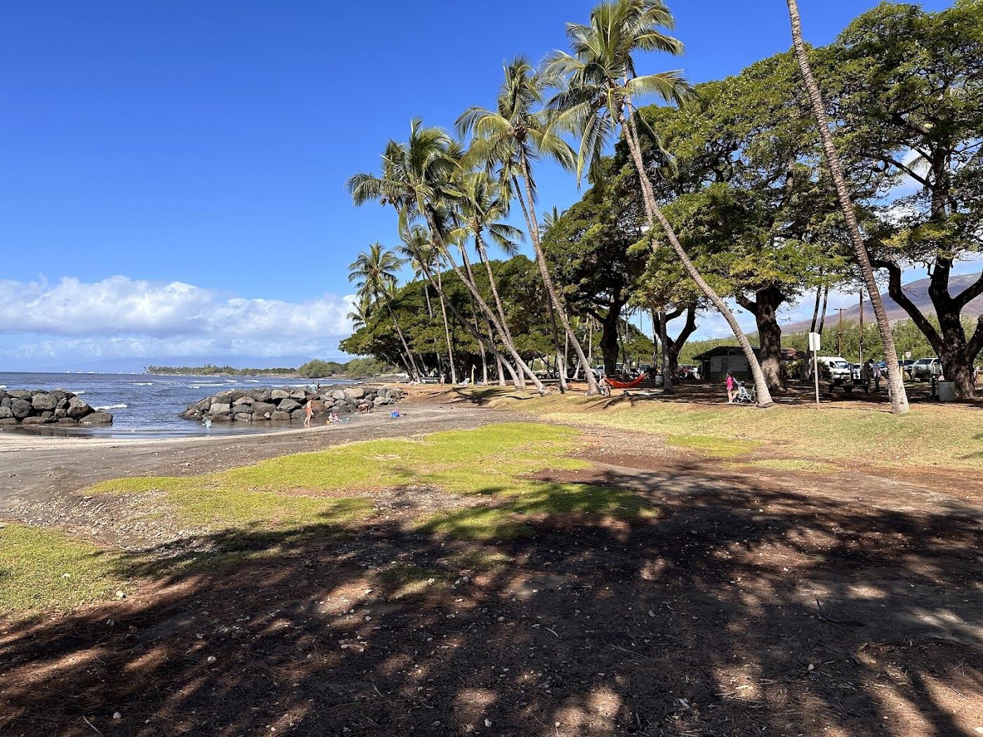 The rock walled keiki pool and gentle surf break at Launiupoko Beach Park south of Lahaina on Maui