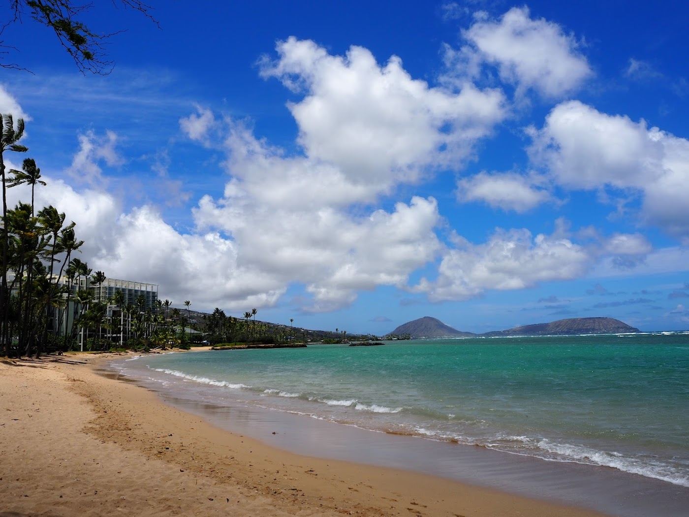 The quiet sandy pockets and shallow reef flat of Kahala Beach in east Honolulu on Oahu