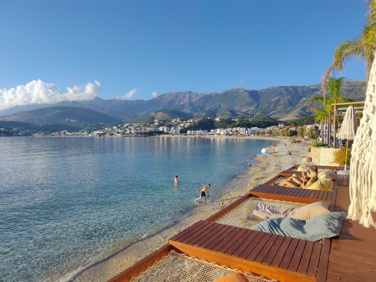 The clearer water and beach clubs at the Potami end of the Himare bay on the Albanian Riviera