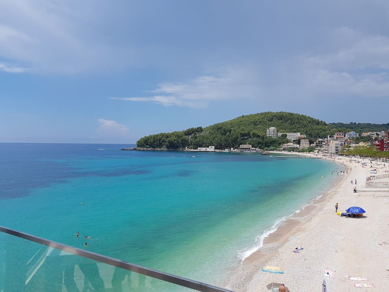 The town beach and bay at Himare on the Albanian Riviera below its hillside castle