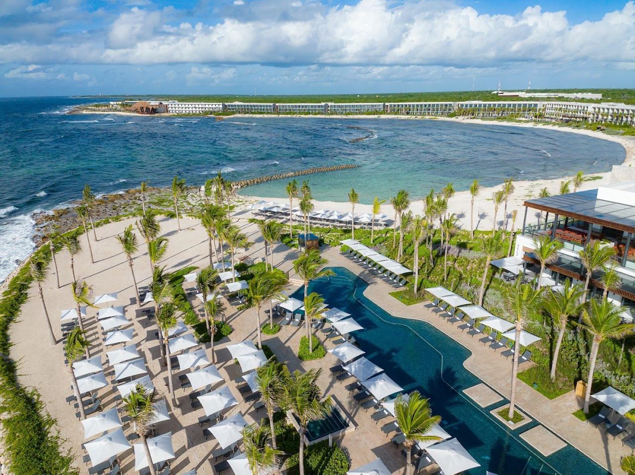 White Caribbean sand and turquoise water backed by cenotes and Mayan ruins along the Yucatan coast.