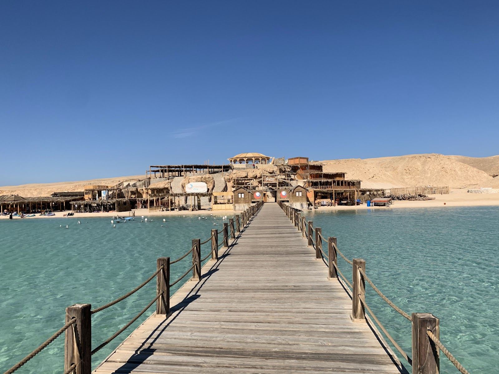 Loungers on a bright sand spit above the clear Red Sea on a Giftun island day club near Hurghada