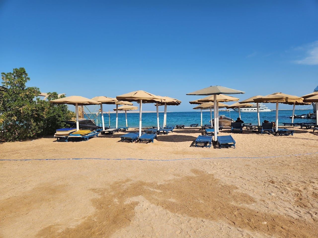 Sunbeds and umbrellas on the calm sand of Old Vic public beach in central Hurghada