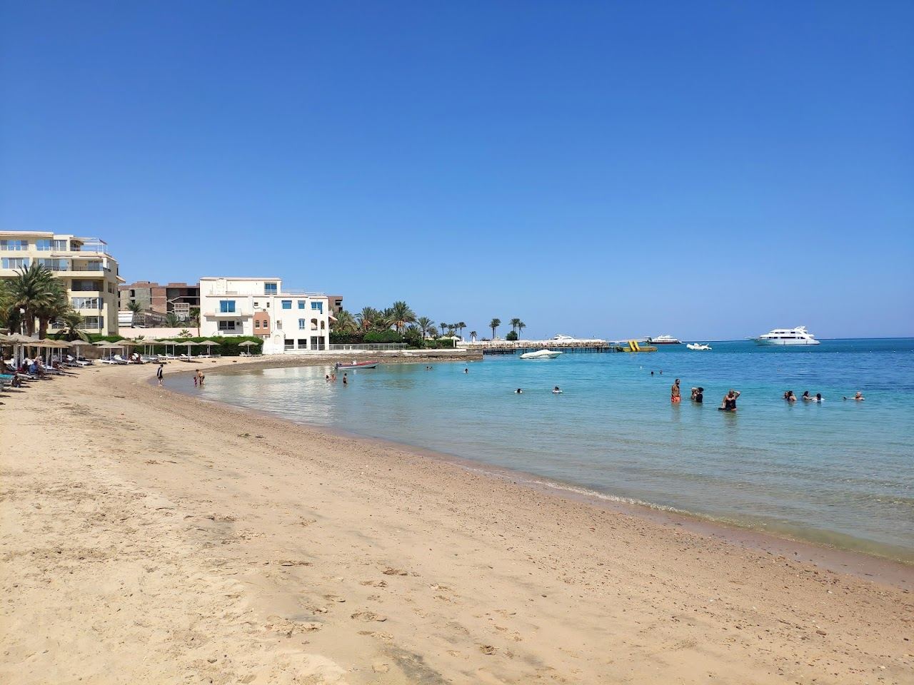 The calm shallow water and soft sand of Old Vic Beach, a public beach in central Hurghada on the Red Sea in Egypt