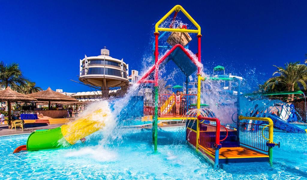 A hotel beach with loungers and calm water near the Sakkala marina in central Hurghada