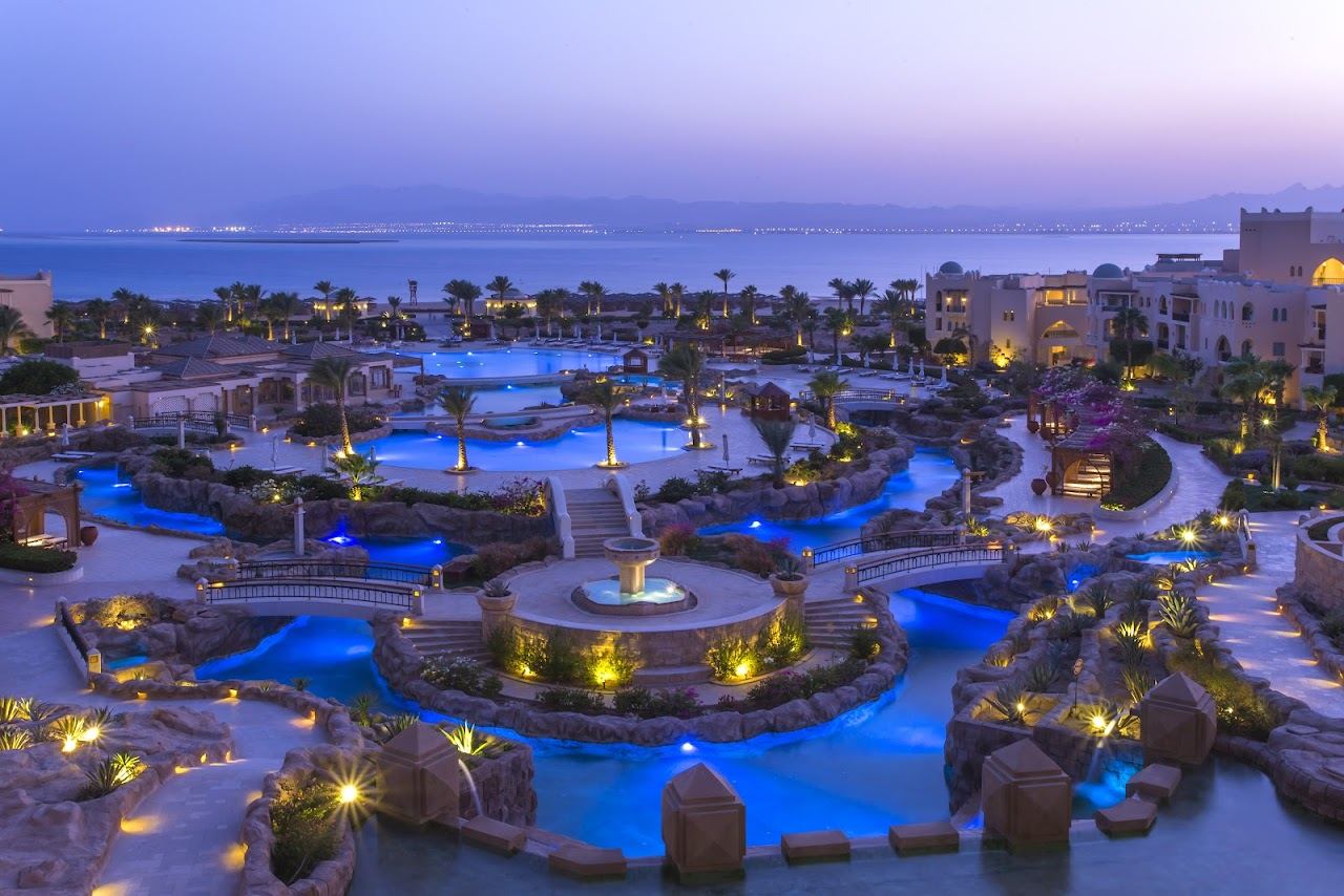 A wide calm resort beach with loungers and shallow lagoon water at Soma Bay near Hurghada