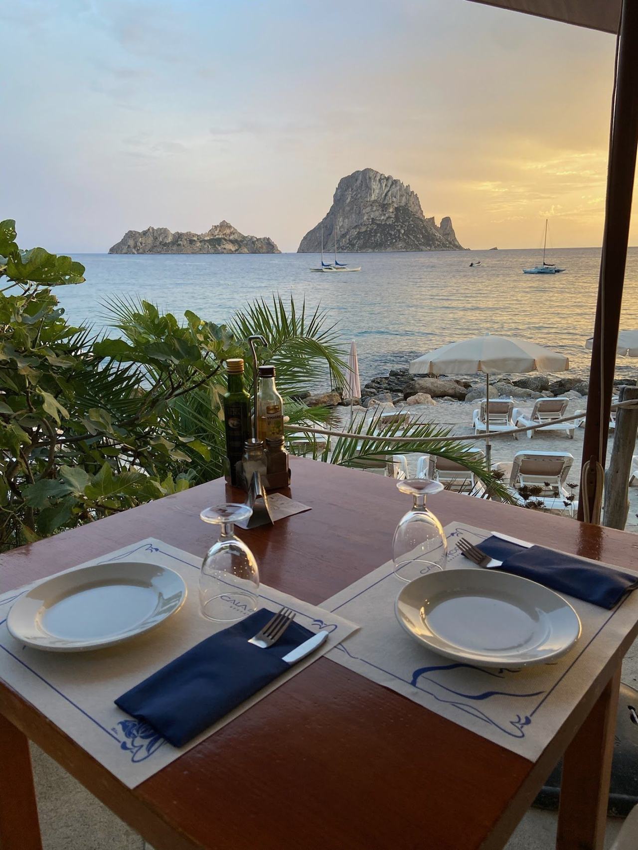 Small sheltered cove at Cala dHort on the southwest coast of Ibiza with Es Vedra offshore