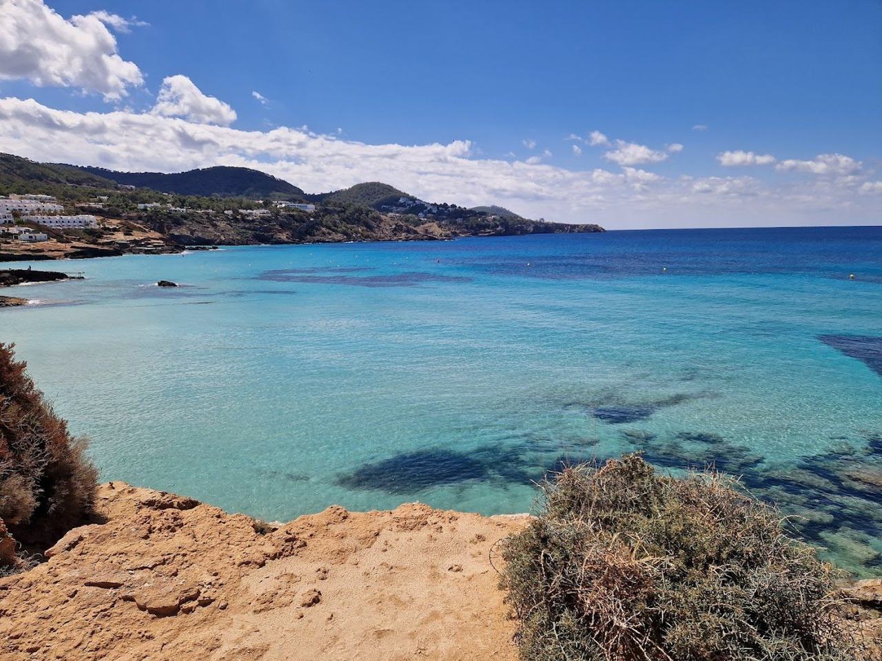 Wide sandy bay with clear shallow water at Cala Tarida on the west coast of Ibiza