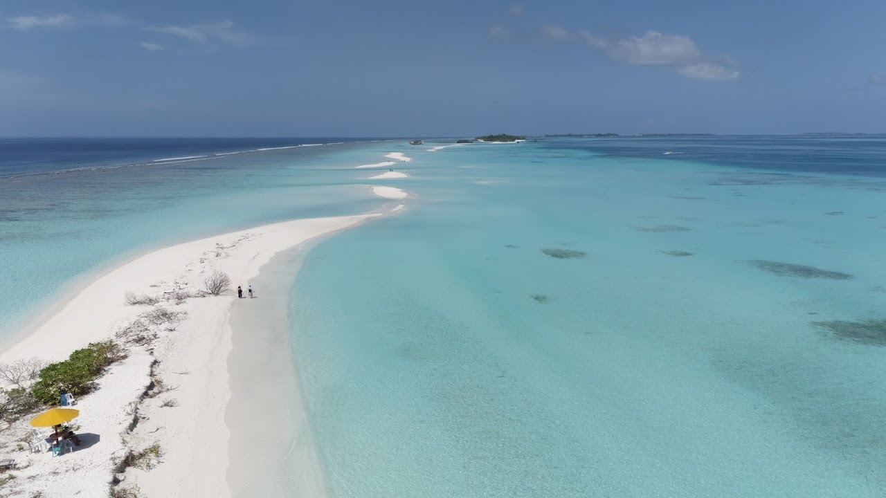 The long white sandbank stretching off Dhigurah island in South Ari Atoll, Maldives