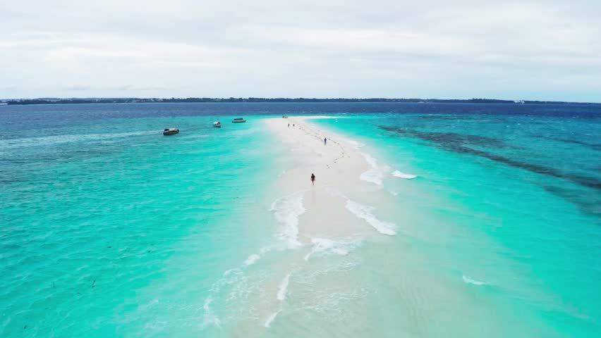 The pure white sandbank of Nakupenda appearing in the marine reserve off Stone Town in Zanzibar
