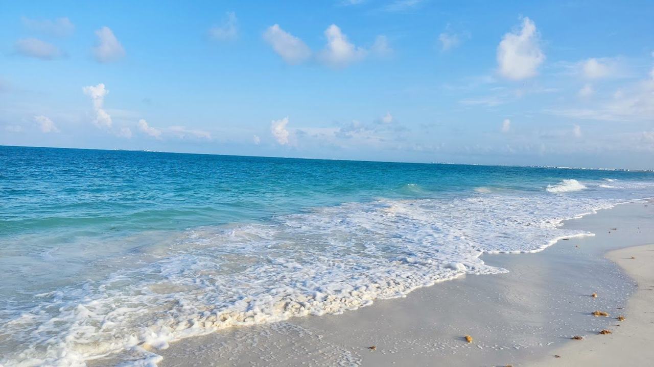 A wild, undeveloped strip of white sand and clear water at remote Isla Blanca north of Cancun
