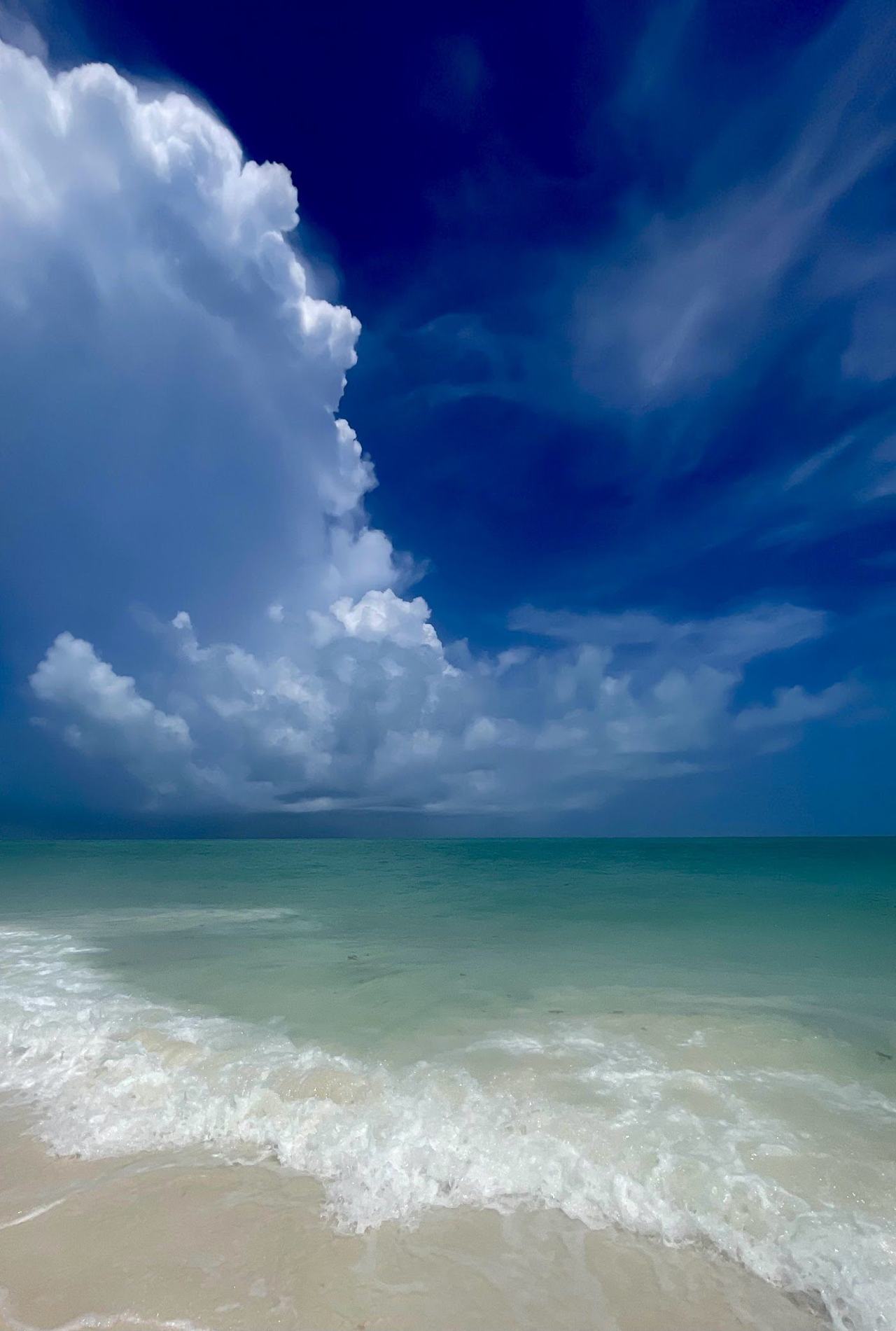 Shallow flat lagoon water and empty white sand along the Isla Blanca peninsula