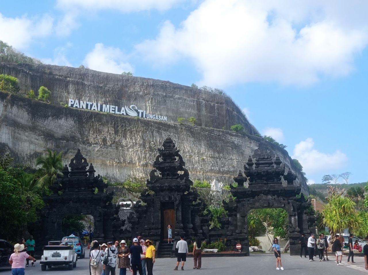 The white sand and turquoise water of Melasti beach below tall cliffs on Bali