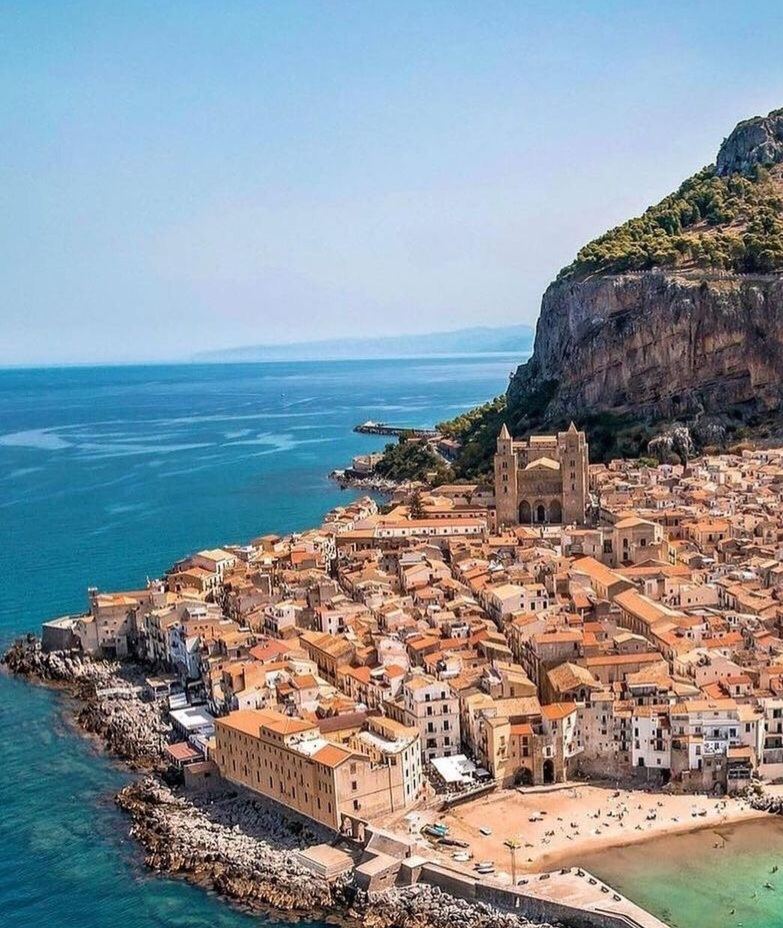 Cefalu in Palermo, Sicily with clear water and sand