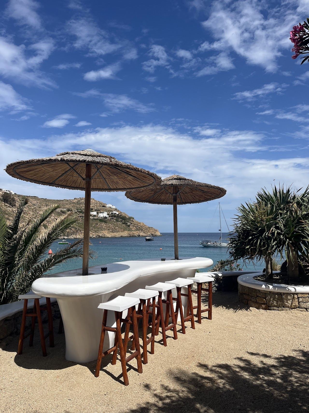 Pool deck and lounge terrace at Jackie O' Beach Club above Super Paradise in Mykonos