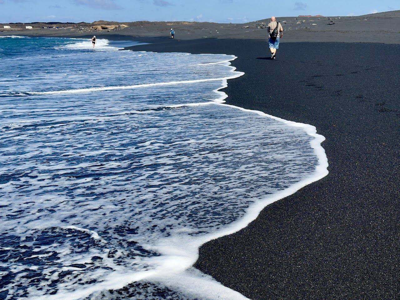 Wild black volcanic sand and the geometric salt pans of the Salinas de Janubio in southwest Lanzarote