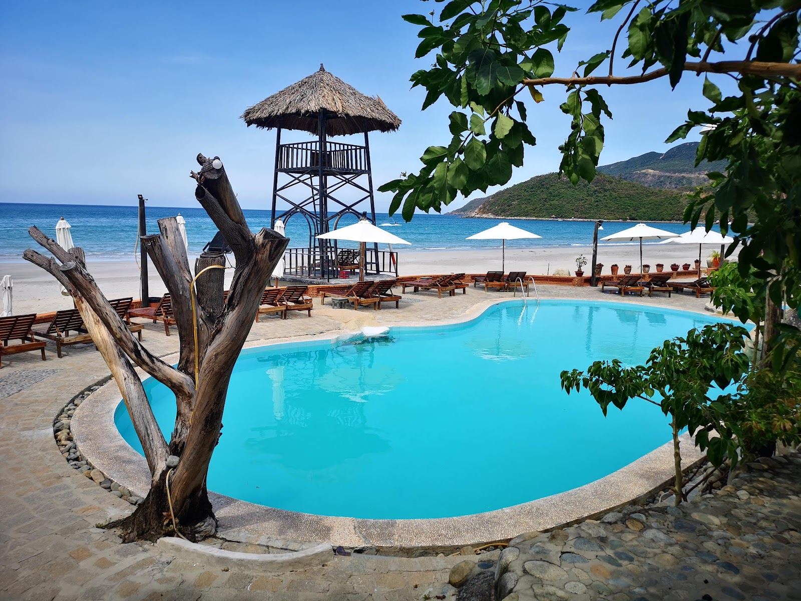 The remote quiet sand of Jungle Beach backed by forested hills on the Hon Heo peninsula north of Nha Trang in Vietnam