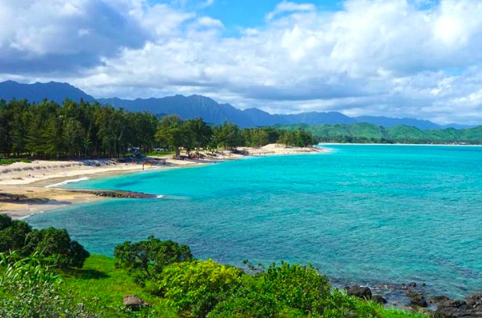 Wide white sand and turquoise water at Kailua Beach Park with offshore islands and a clear sky