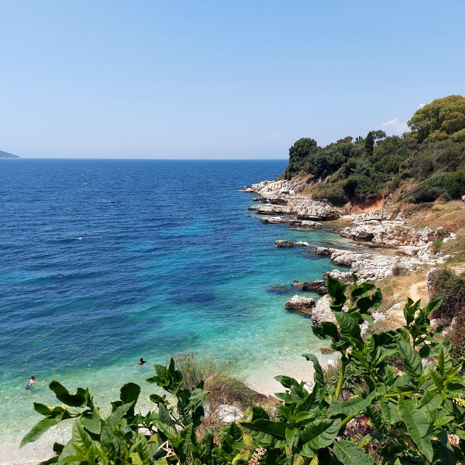White pebble cove and turquoise water near Kassiopi on the northeast coast of Corfu
