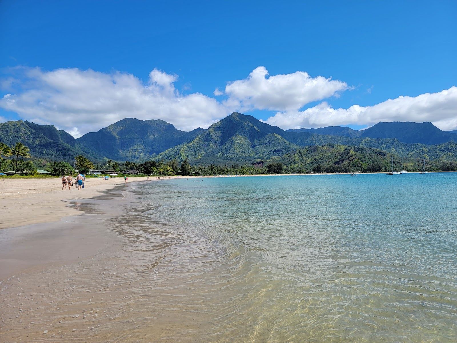 The two mile golden crescent of Hanalei Bay under emerald mountains on the north shore of Kauai