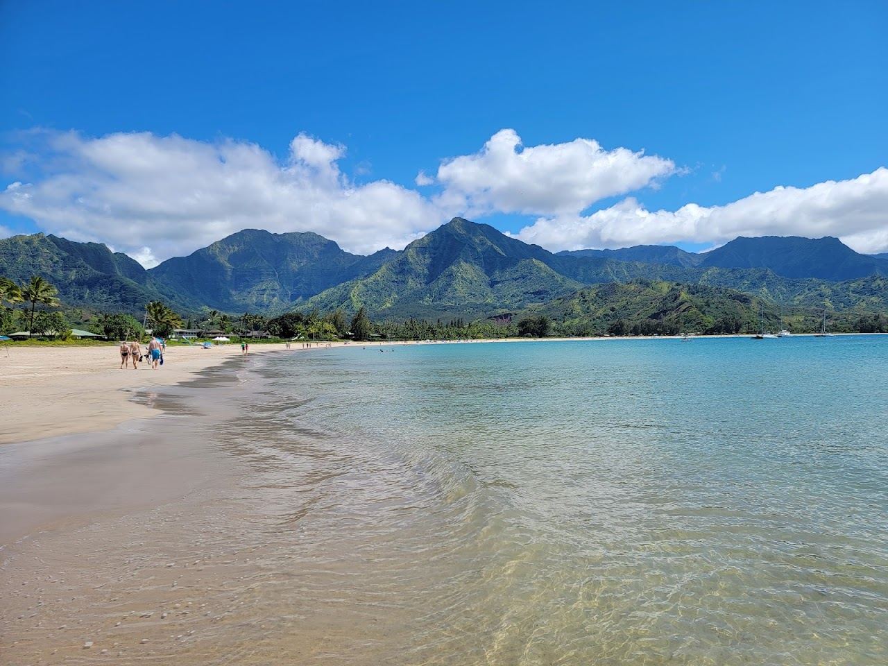 The green mountains and wide crescent of sand at Hanalei Bay on the north shore of Kauai