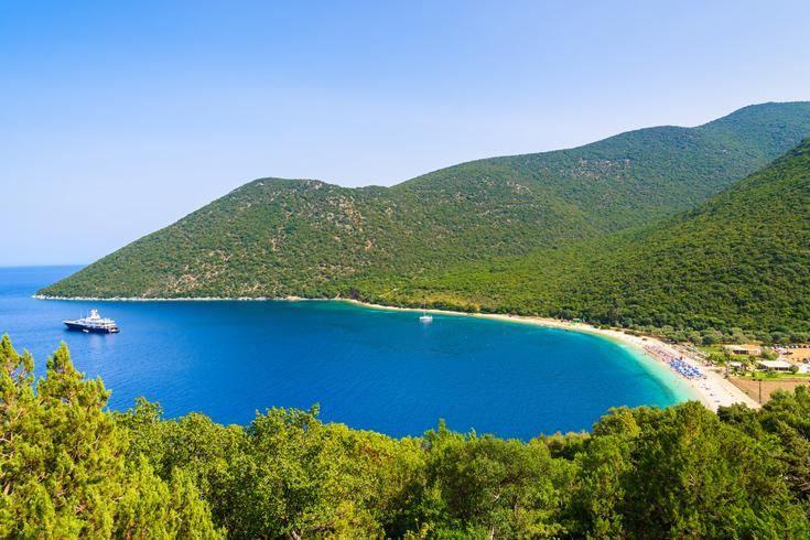 The green hills and calm clear bay of Antisamos Beach near Sami in Kefalonia