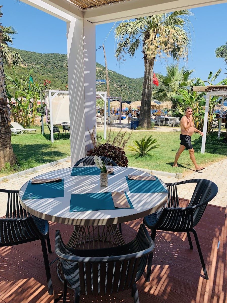 Sunbeds and turquoise water at Antisamos beach near Sami in Kefalonia