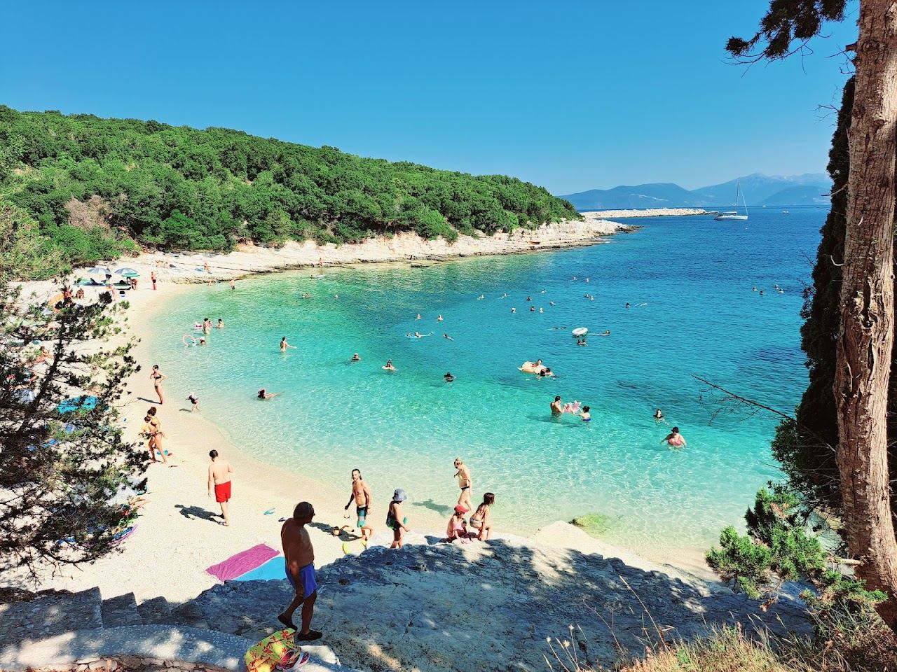 The clear turquoise water and pale pebbles of Emblisi Beach near Fiskardo in Kefalonia