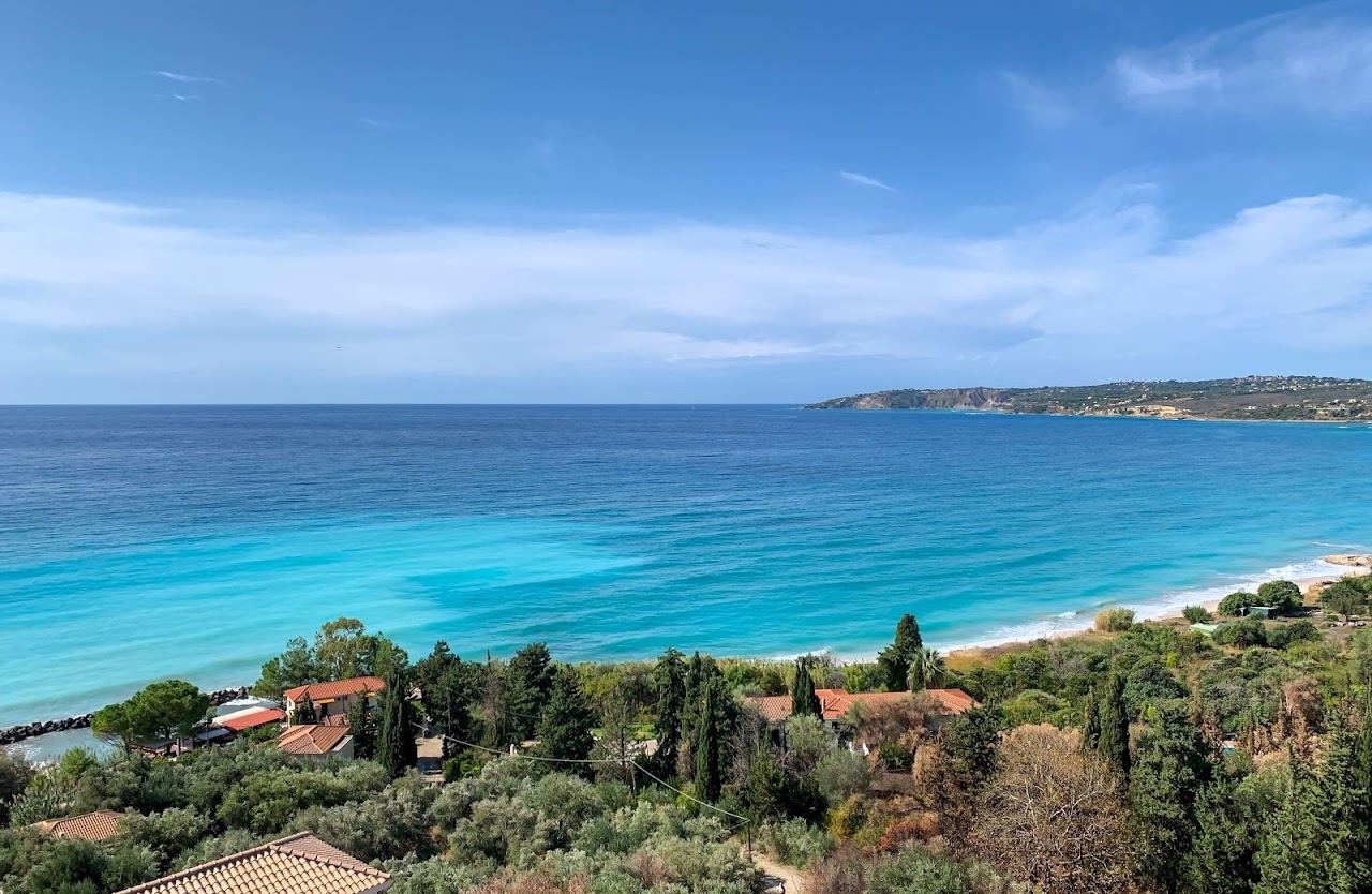 The long sandy sweep and green hills of Lourdas Beach in south Kefalonia
